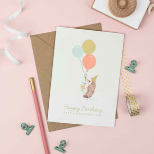 Hedgehog with colourful balloons birthday card for children.